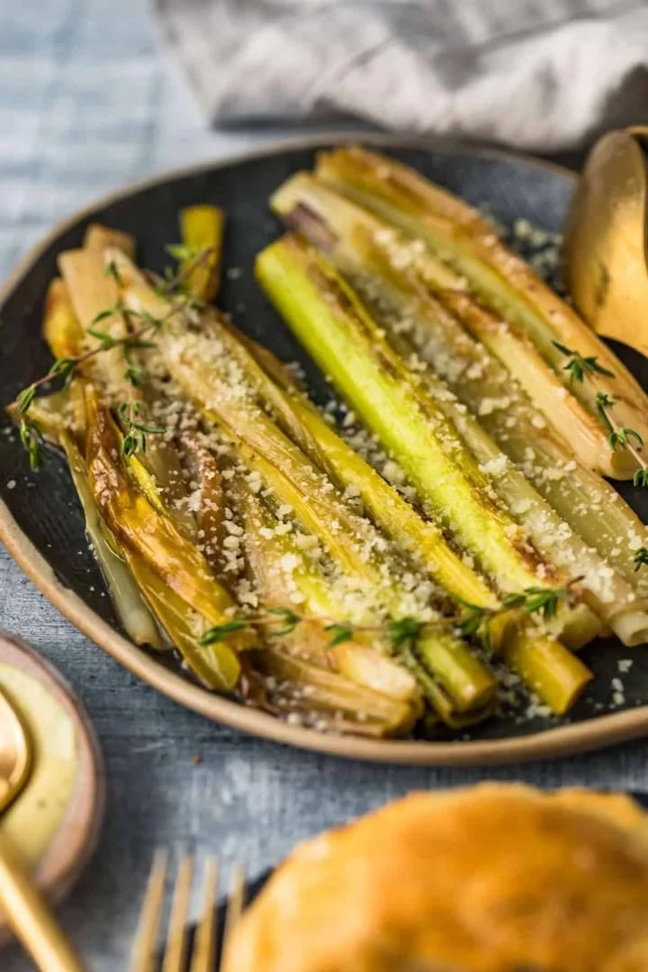 Plate of sautéed leeks topped with parmesan cheese