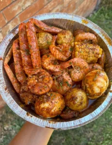 Delicious seafood boil with shrimp, crab, corn, and potatoes served in a vibrant setting.