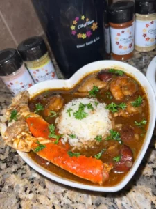A delicious bowl of Seafood Gumbo served with fresh herbs and seafood.