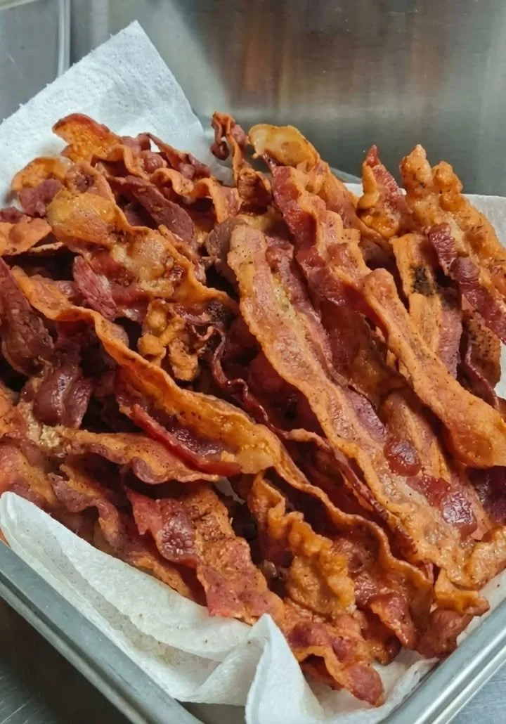 Plate of perfectly cooked crispy bacon ready to enjoy
