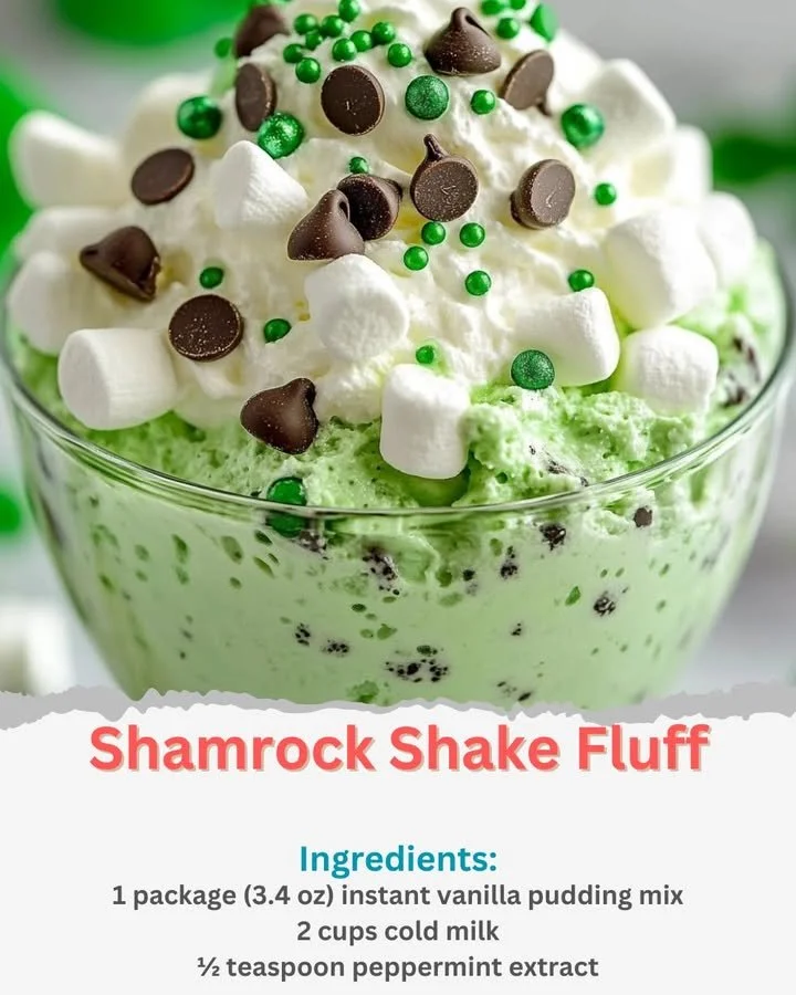 A bowl of Shamrock Shake Fluff topped with whipped cream and mint.