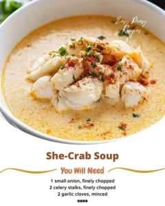 Rich and creamy She-Crab Soup garnished with crab meat and herbs