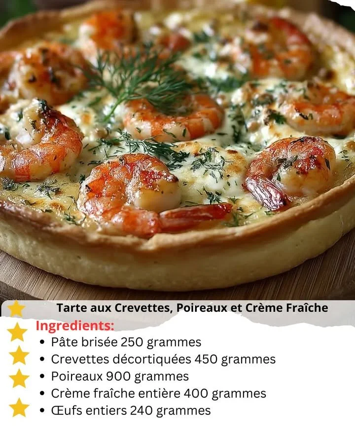 Shrimp tart topped with leeks and crème fraîche on a rustic wooden table