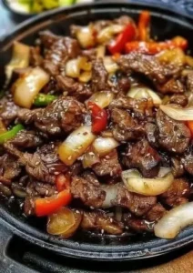 Sizzling Chinese pepper steak with onions served in a bowl