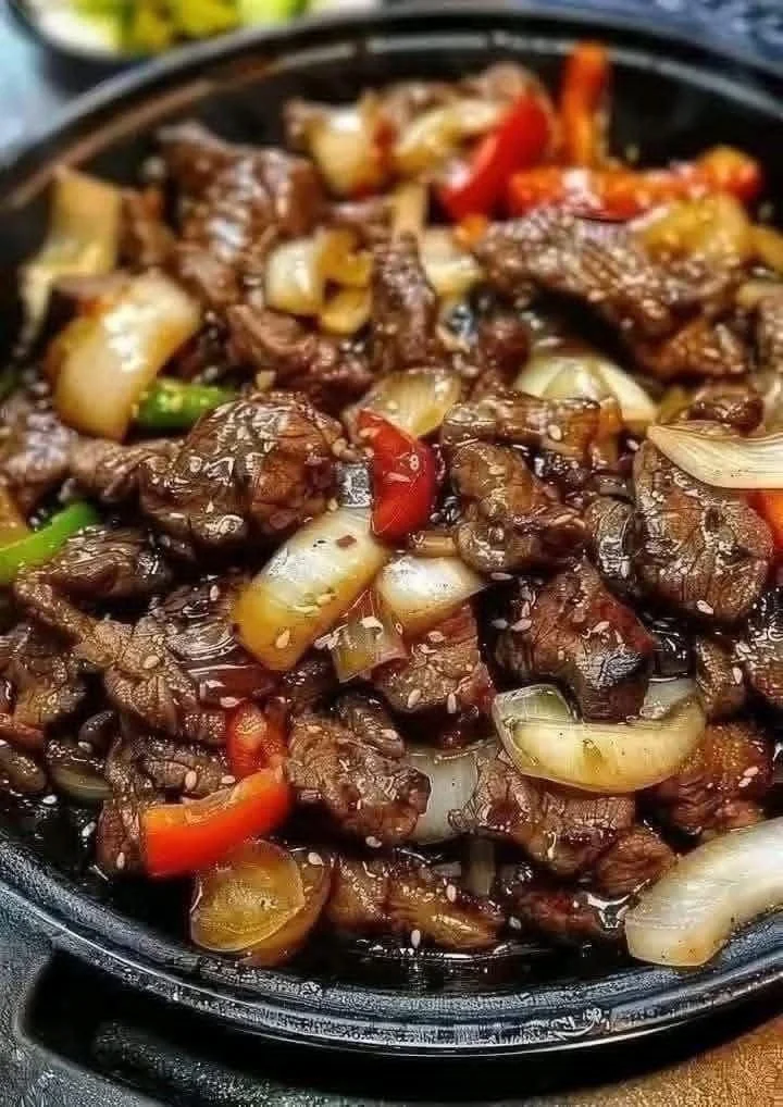 Sizzling Chinese pepper steak with onions served in a bowl