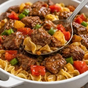 Delicious slow cooker pepper steak served with fresh vegetables.