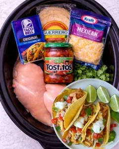 Slow cooker salsa chicken tacos served in tortillas with toppings