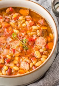 Delicious slow-cooker sausage three-bean soup in a rustic bowl