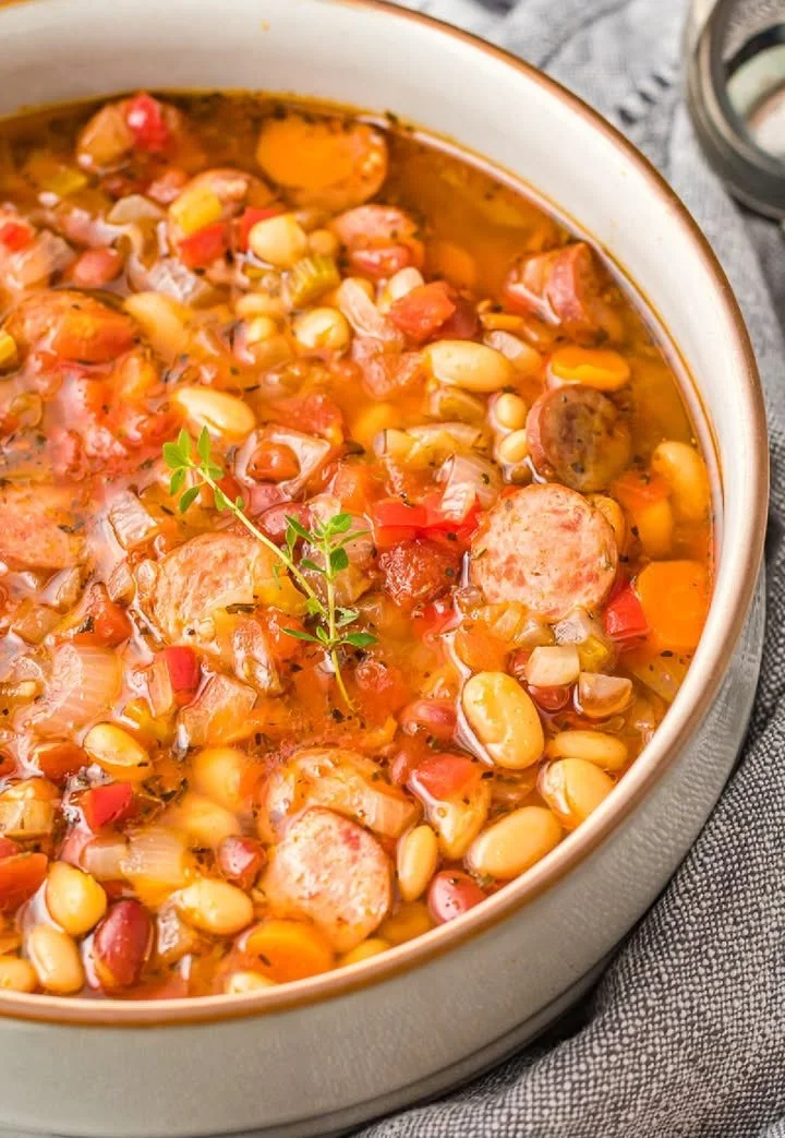 Delicious slow-cooker sausage three-bean soup in a rustic bowl