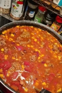A delicious bowl of slow cooker taco soup, topped with cheese and cilantro.