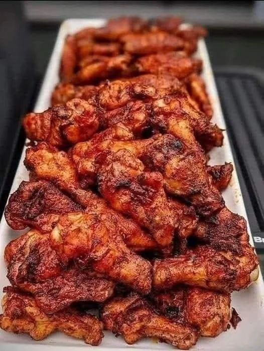 Juicy smoked chicken wings on a grill with rich flavors