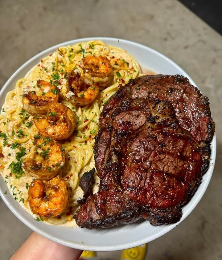 Delicious smoked ribeye steak served with shrimp alfredo sauce