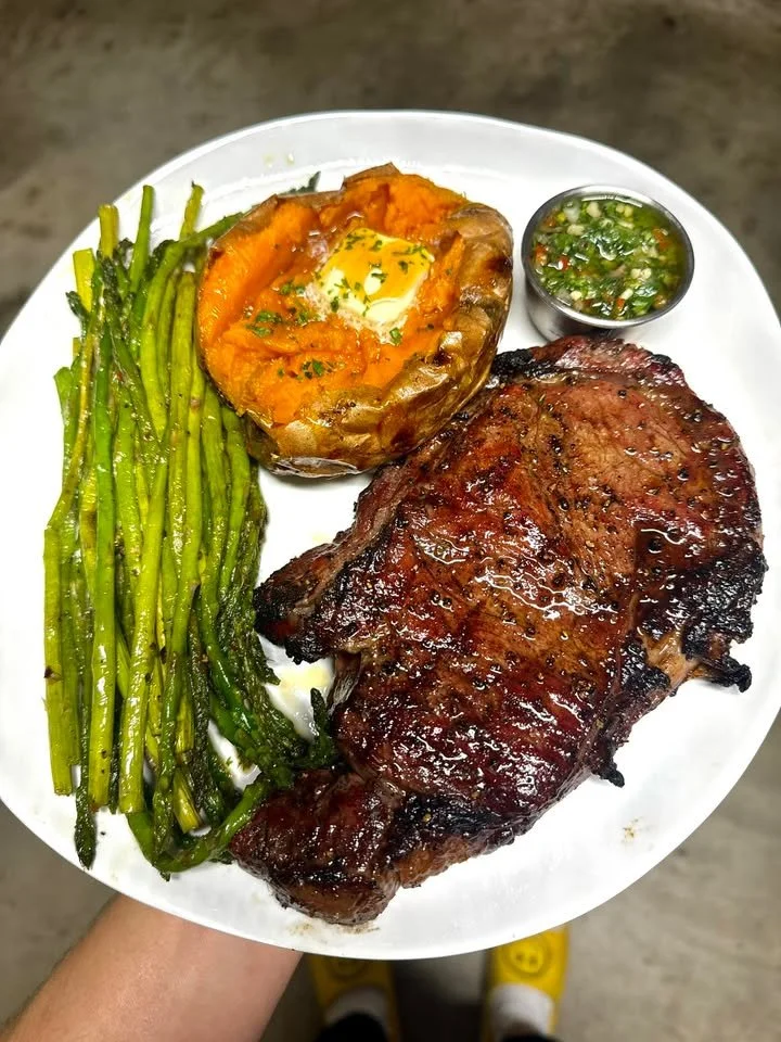 Smoked ribeye steak with sweet potato and chimichurri sauce on a plate