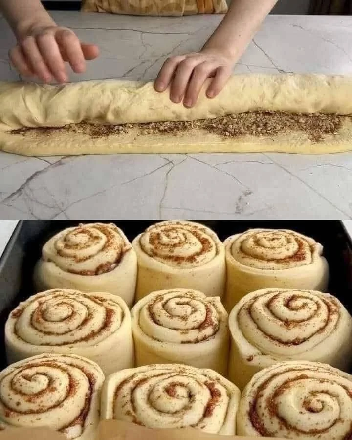 Delicious soft cinnamon-walnut rolls with cream cheese frosting on a plate