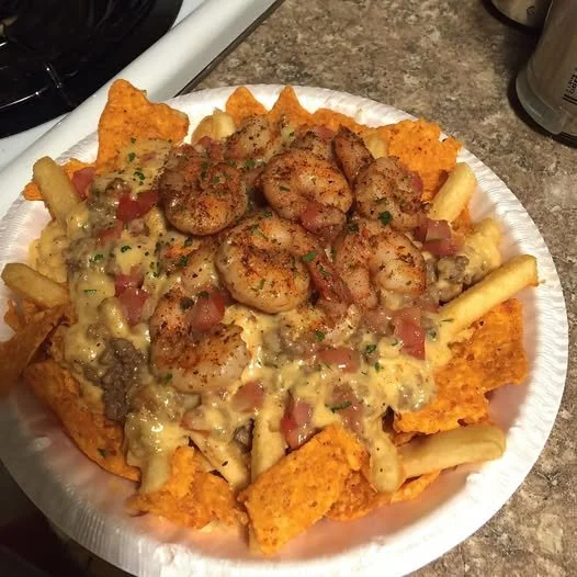 Delicious Southern Bayou shrimp nacho fries topped with cheese and spices.