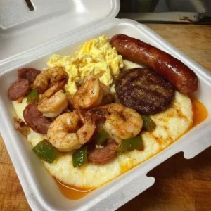 Southern breakfast shrimp and grits plate with sausage and eggs