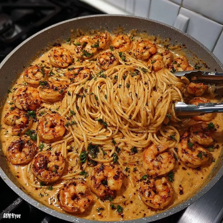 Plate of Southern Spicy Shrimp Spaghetti garnished with herbs