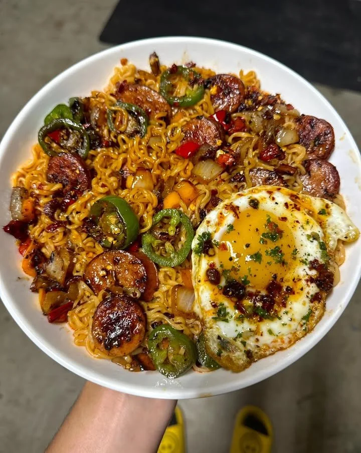 Bowl of spicy jalapeno sausage ramen topped with a fried egg