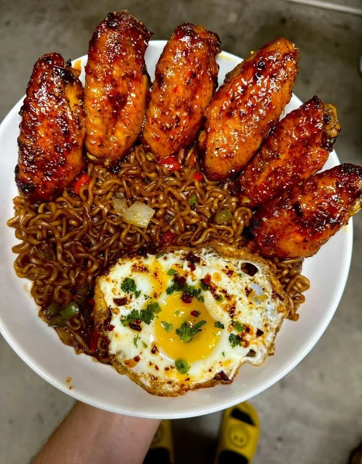 Delicious spicy wings served with a black bean noodle bowl