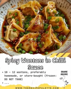 Plate of spicy wontons drizzled with chilli sauce, ready to eat.