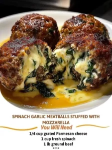 Spinach garlic meatballs stuffed with mozzarella cheese on a serving plate