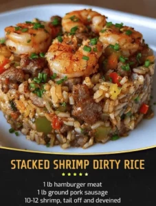 Stacked shrimp dirty rice served in a bowl with garnishes and spices