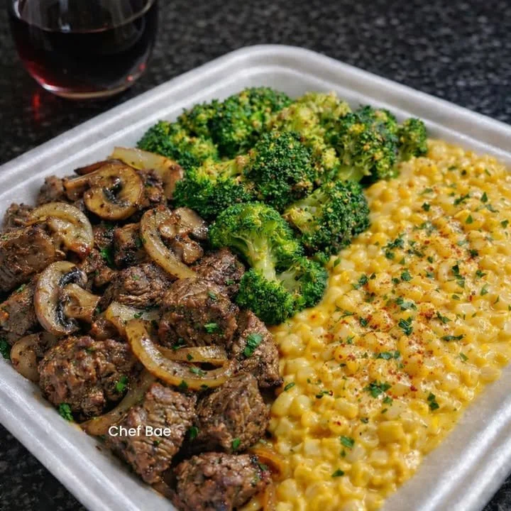 Savory steak bites served with broccoli and creamed corn