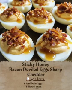 Sticky Honey Bacon Deviled Eggs topped with Sharp Cheddar on a serving platter