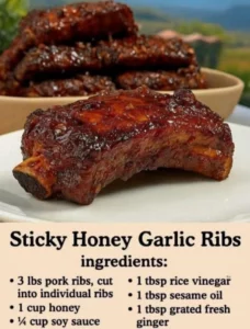Delicious sticky honey garlic ribs served on a plate garnished with herbs.