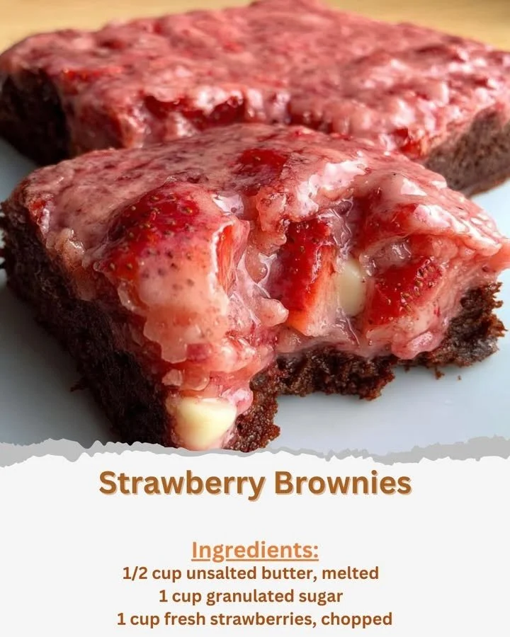 Delectable strawberry brownies topped with fresh strawberries and chocolate drizzle.