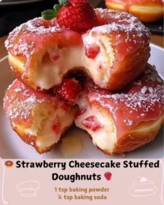 Strawberry cheesecake stuffed doughnuts topped with fresh strawberries