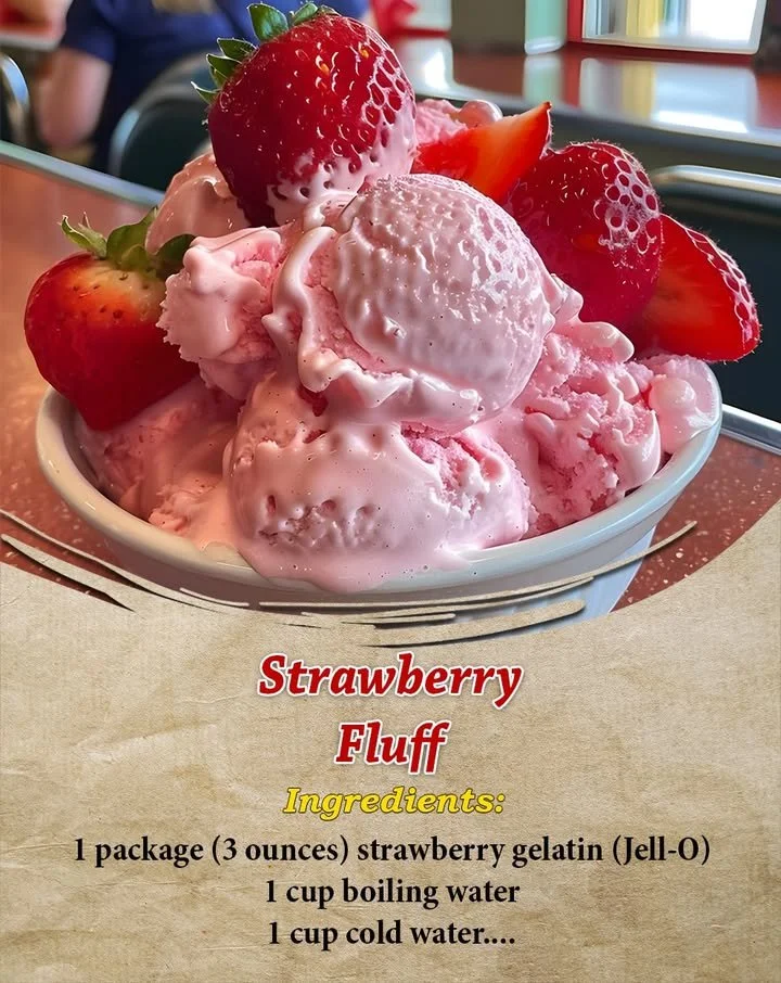 A bowl of creamy Strawberry Fluff dessert topped with fresh strawberries.