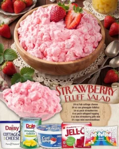 A bowl of Strawberry Fluff Salad with fresh strawberries and whipped cream.
