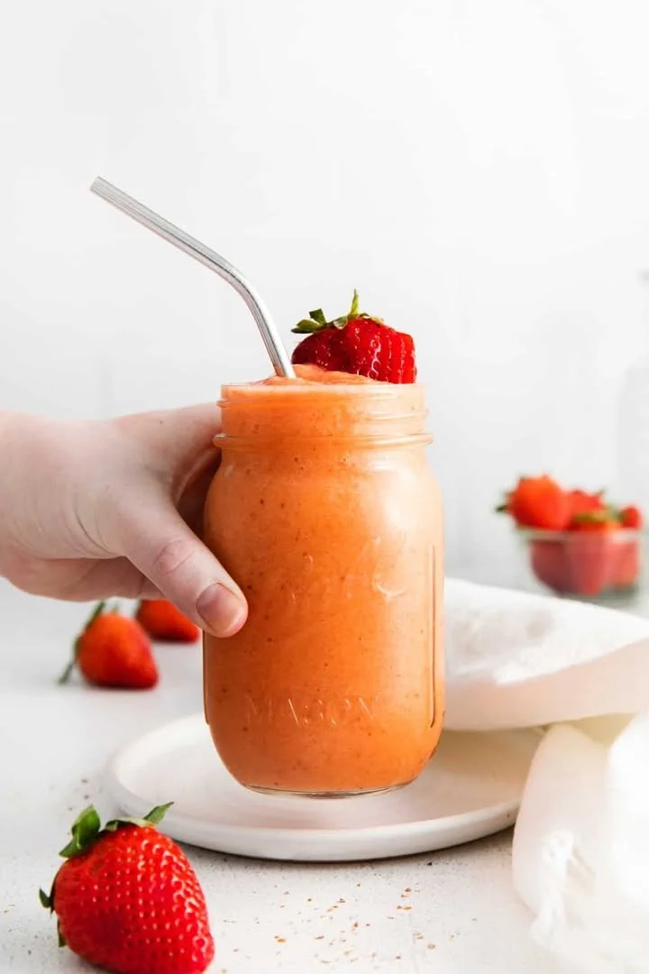 Delicious strawberry mango smoothie served in a glass with fresh fruits