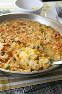 Delicious Street Corn Chicken Casserole topped with cheese and fresh corn