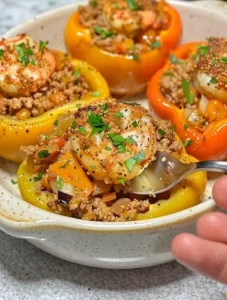 Colorful stuffed bell peppers filled with rice, vegetables, and cheese