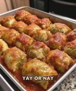 Plate of homemade stuffed cabbage rolls with tomato sauce