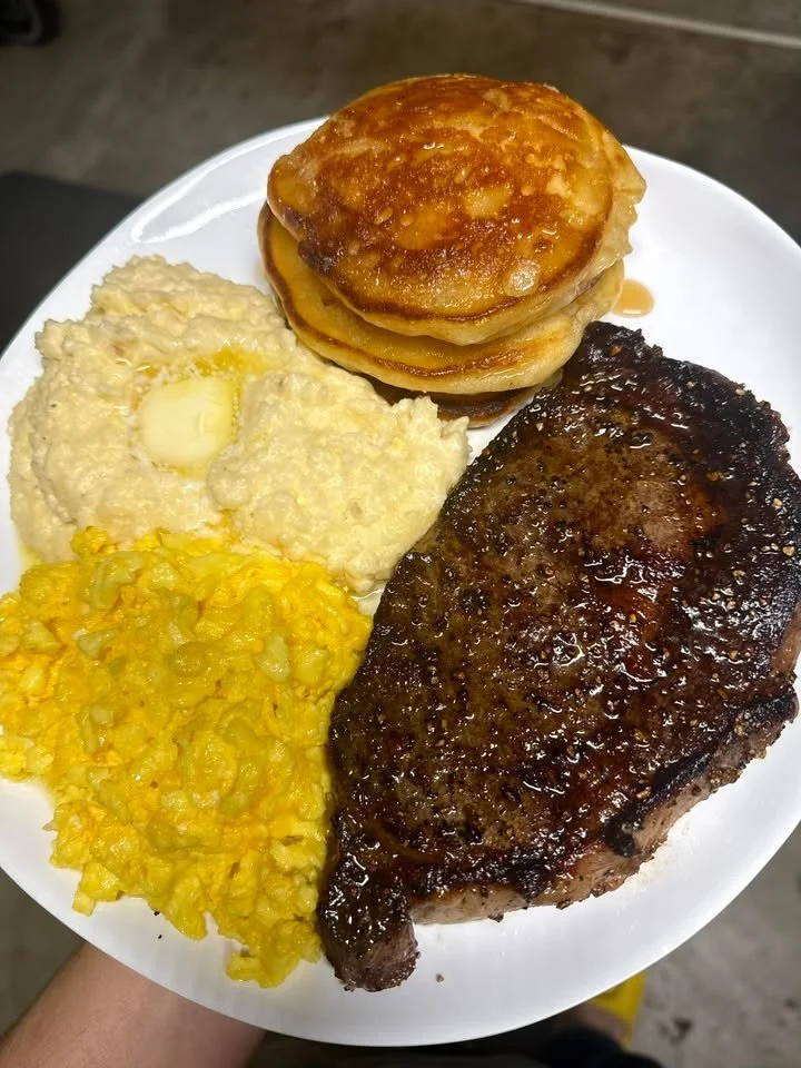 Delicious Sunday breakfast spread with pancakes, eggs, and coffee.