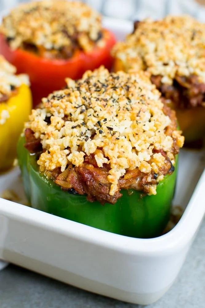 Colorful taco stuffed bell peppers filled with seasoned beef, cheese, and veggies