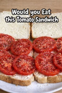 Delicious homemade tomato sandwich with fresh ingredients on a wooden table