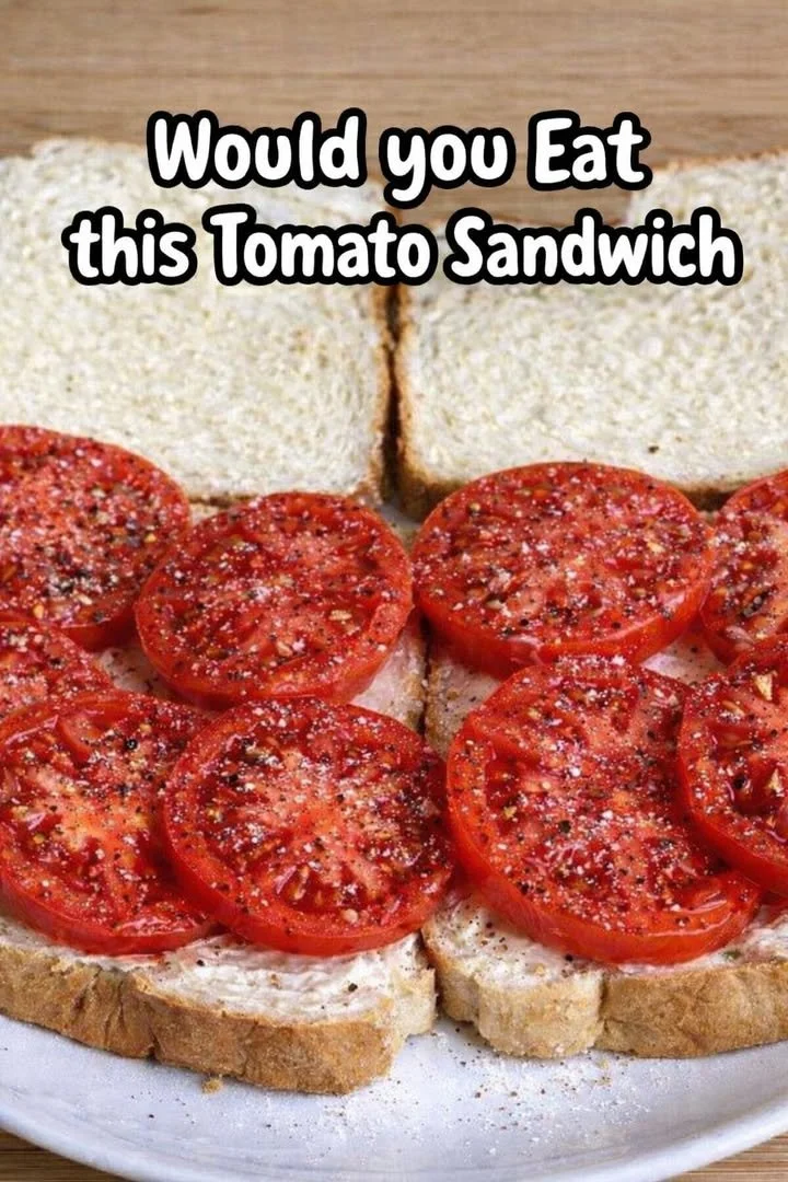 Delicious homemade tomato sandwich with fresh ingredients on a wooden table