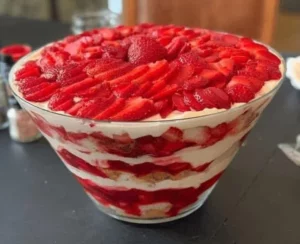 Delicious layered trifle dessert with fruits and cream