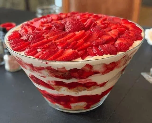 Delicious layered trifle dessert with fruits and cream