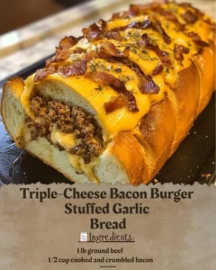 Triple-Cheese Bacon Burger stuffed in garlic bread on a plate