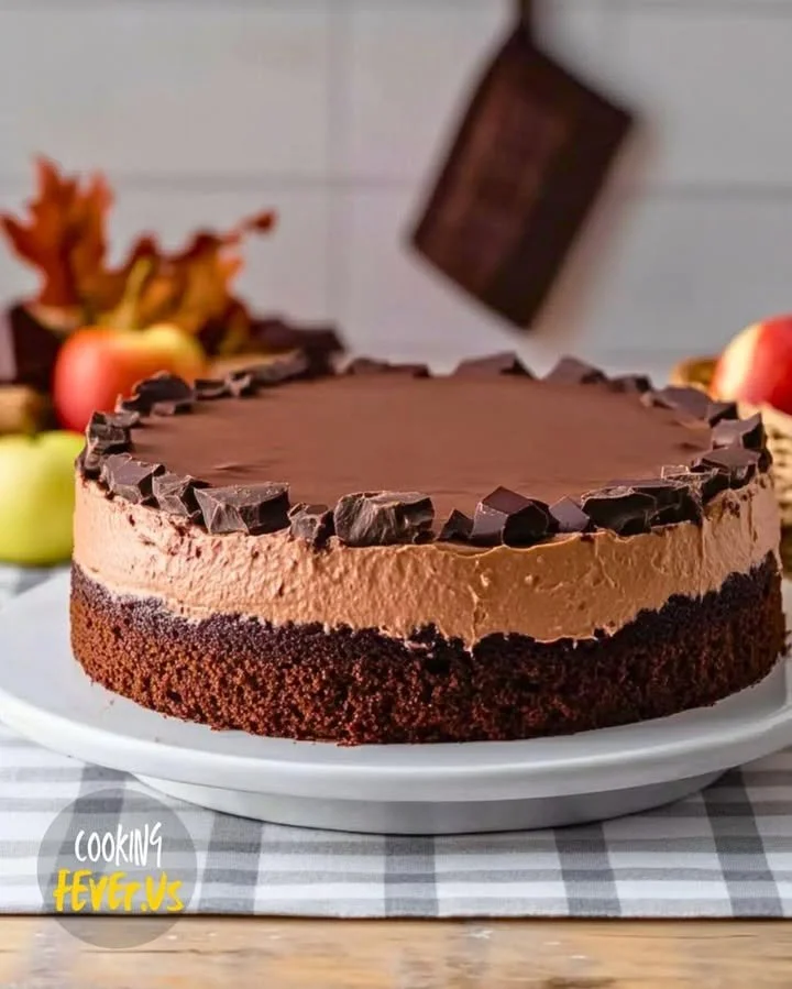 Delicious triple chocolate mousse cake topped with chocolate shavings.