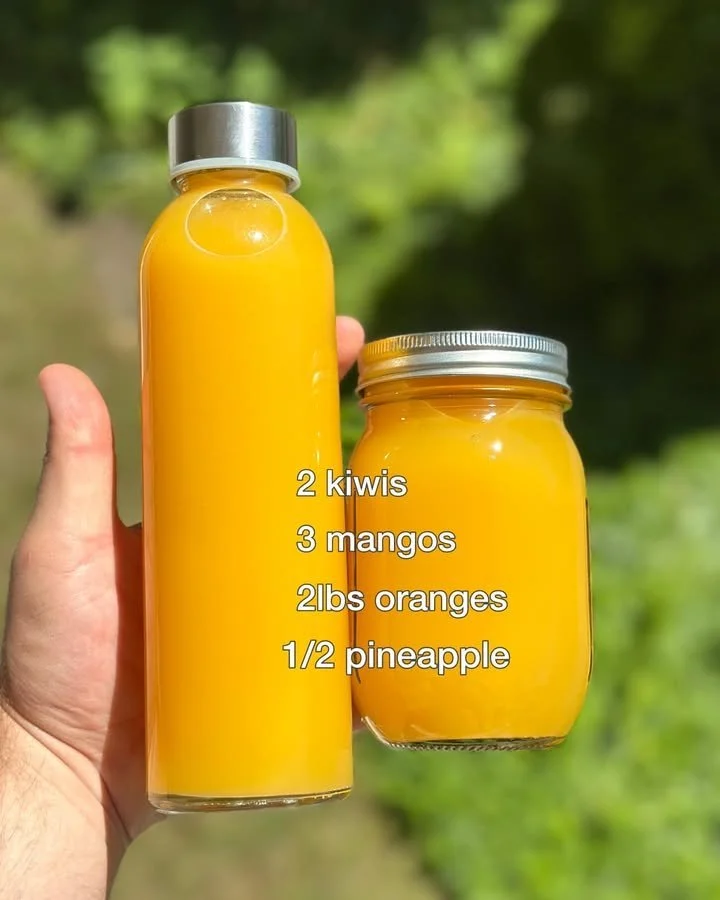 Freshly squeezed Tropical Orange Juice in a glass with a slice of orange.