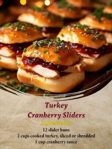 Turkey Cranberry Sliders served on a platter with fresh herbs and cranberry sauce.