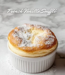 Delicious Vanilla Soufflé served in a ramekin, showcasing its fluffy texture.