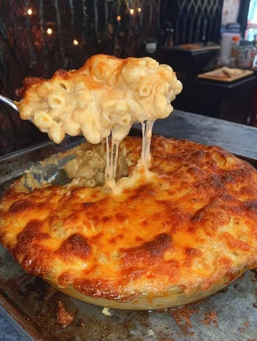 Creamy Vegan Baked Mac and Cheese in a ceramic dish topped with breadcrumbs