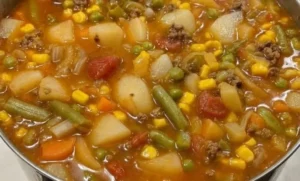 A bowl of hearty vegetable beef soup with colorful veggies and tender beef.
